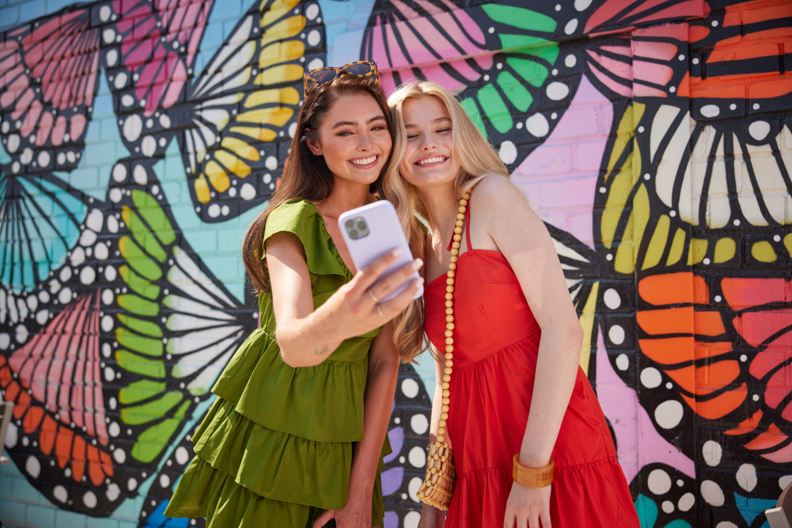 girls in front of butterfly mural