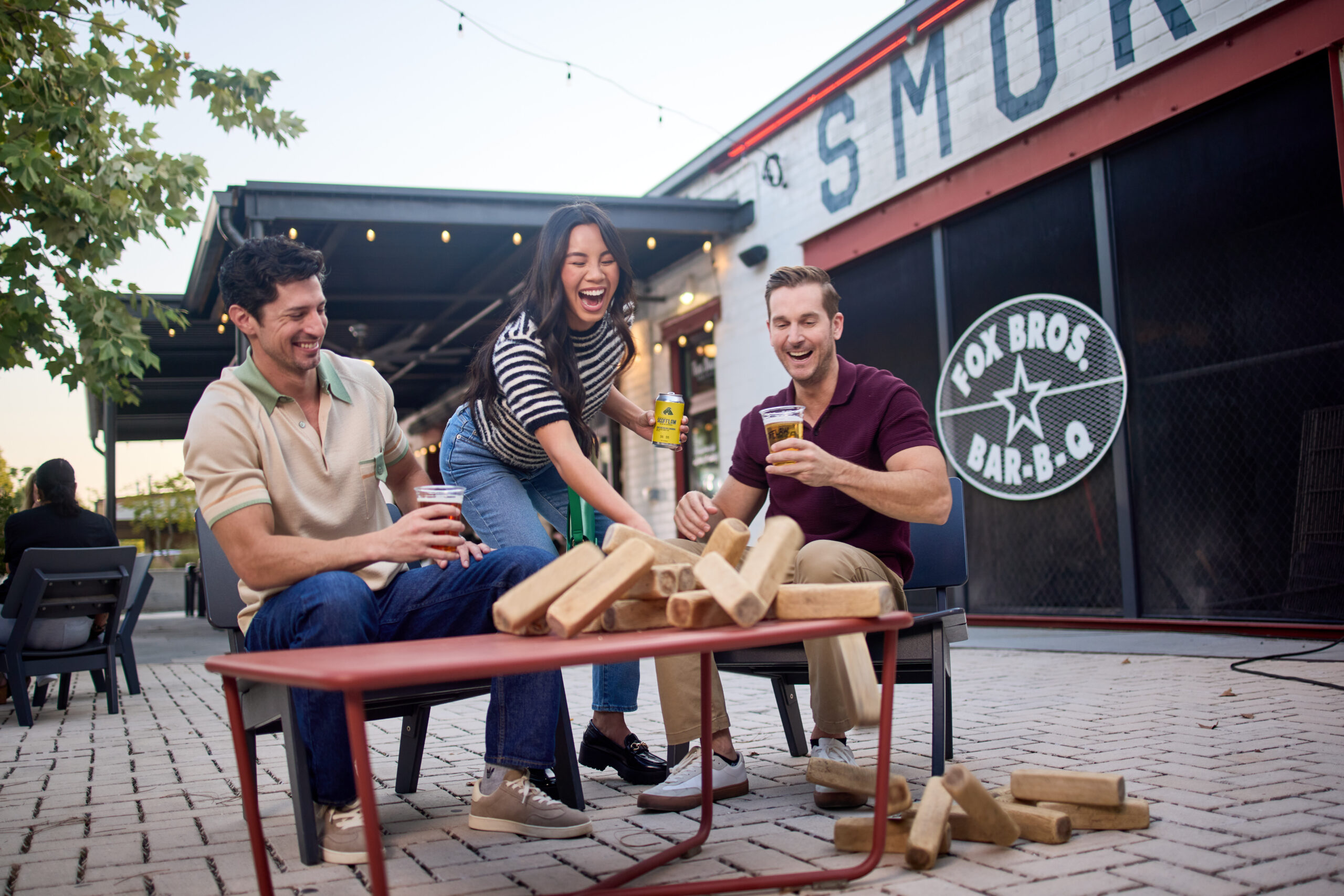 group playing Jenga outside Fox Bros Bar-B-Q